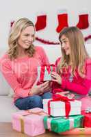 Festive mother and daughter with many gifts