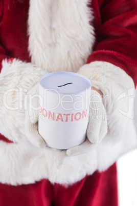 Santa holds a can for donations Santa holds a can for donations