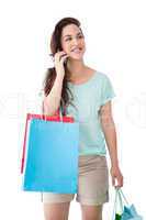 Happy blonde with shopping bags on the phone