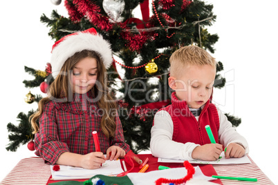 Festive little siblings drawing pictures