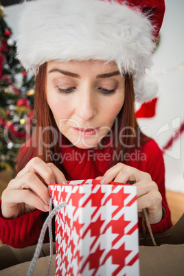 Festive redhead opening christmas gift