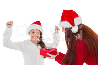 Festive mother giving daughter a gift