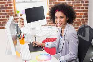 Female photo editor using digitizer in office