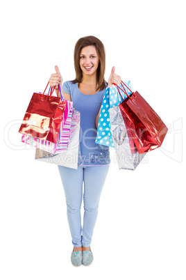 Woman holding shopping bags with the thumbs up