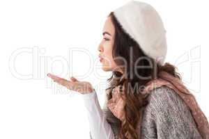 Brunette in winter clothes blowing kiss