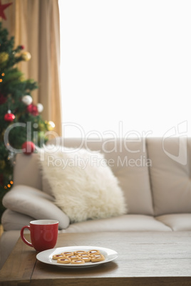 Cookies and mug on coffee table at christmas