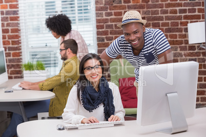 Creative business people using computer