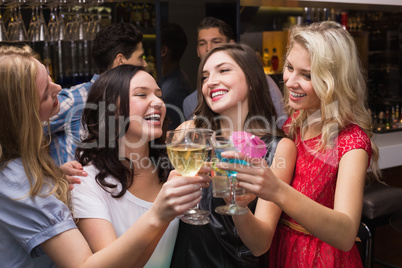 Happy friends having a drink together