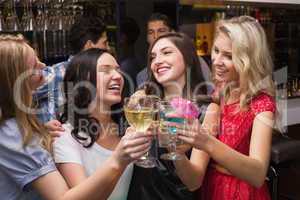 Happy friends having a drink together