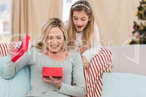 Mother opening christmas gift with daughter