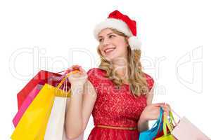 Smiling blonde in santa hat holding shopping bags