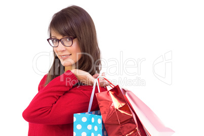 Happy brunette holding shopping bags