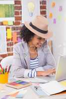 Female interior designer using laptop at desk