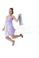 Happy brunette jumping with shopping bag