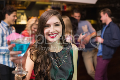 Pretty brunette drinking a cocktail