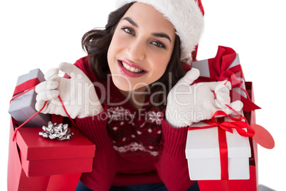 Smiling brunette holding shopping bags full of gifts