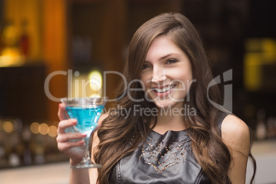 Pretty brunette holding a cocktail