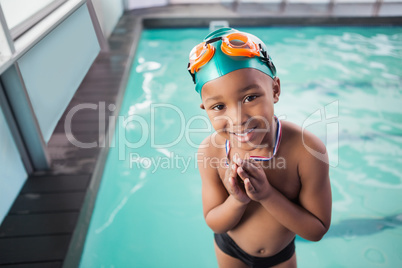 Cute little boy with his medal at the pool