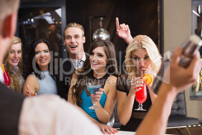 Attractive friends being served cocktails