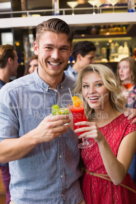 Happy couple drinking cocktails together