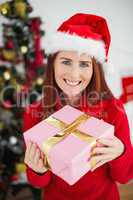 Festive redhead holding christmas gift