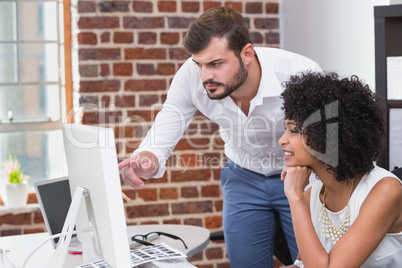 Photo editors using computer in office