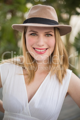 Portrait of a smiling blonde woman wearing hat