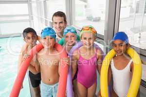 Swimming coach with his students poolside