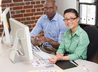 Smiling photo editors in office