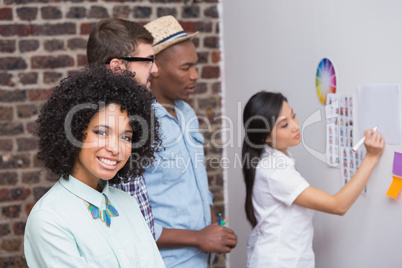 Team looking at sticky notes on wall