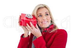 Festive blonde holding red gift