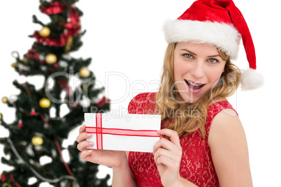 Blonde in santa hat holding a card