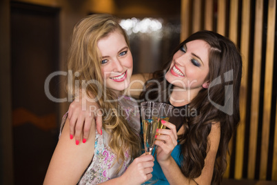 Attractive friends toasting with champagne