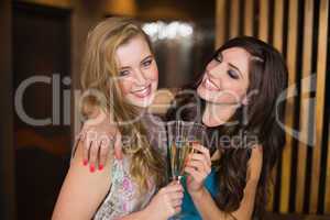 Attractive friends toasting with champagne