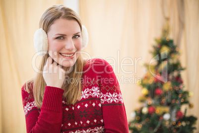 Portrait of a pretty smiling blonde wearing earmuffs