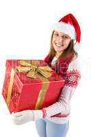 Young woman holding a gift while smiling at camera