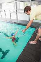 Swimming coach showing time to little girl