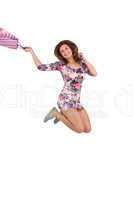 Excited brunette jumping while holding shopping bag