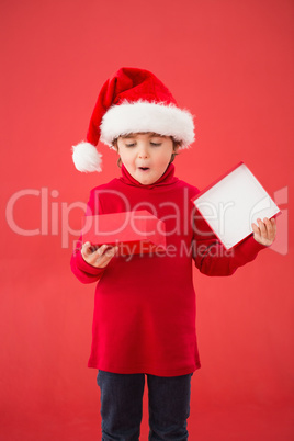 Festive little boy opening a gift