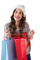 Festive brunette opening shopping bag
