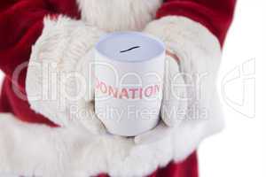 Santa holds a can for donations
