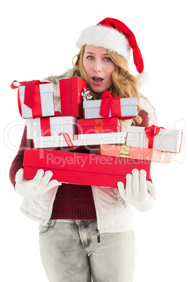 Blonde woman in trouble holding pile of gifts