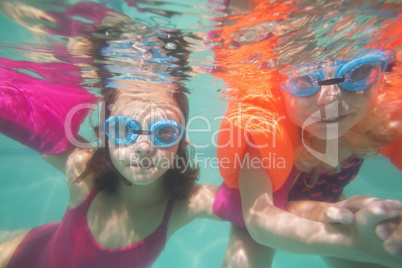 Cute kids posing underwater in pool