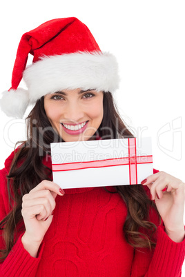 Smiling brunette holding a gift