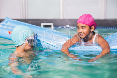 Cute little kids swimming in the pool