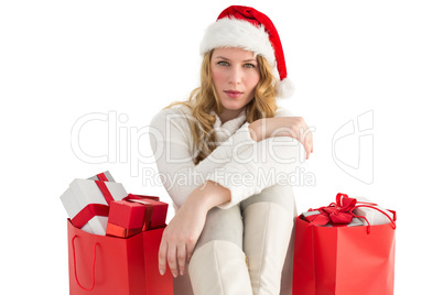 Serious woman sitting on floor with shopping bag