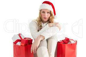 Serious woman sitting on floor with shopping bag