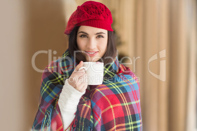 Brunette with cover holding mug