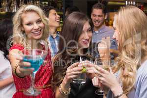 Happy friends having a drink together