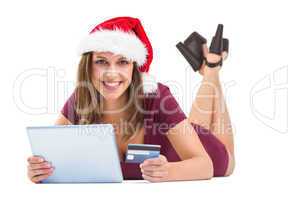 Festive brunette shopping online with tablet